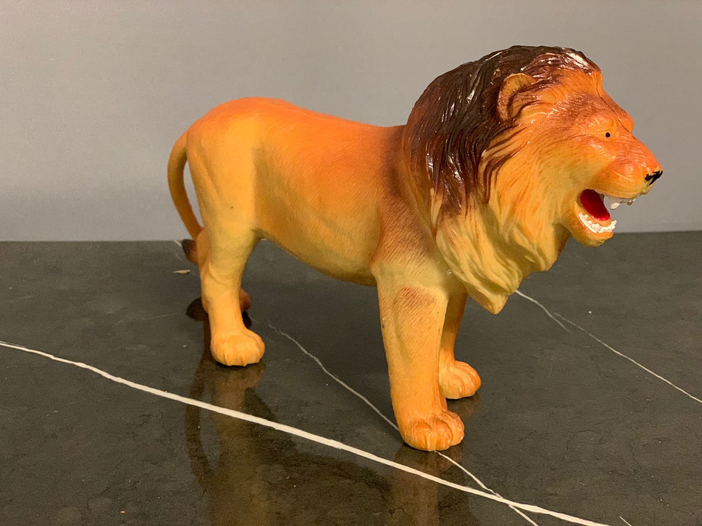 Realistic Plastic Lion Figure.