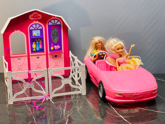 Barbie Glam Convertible car along with two Barbie dolls and a small playhouse.