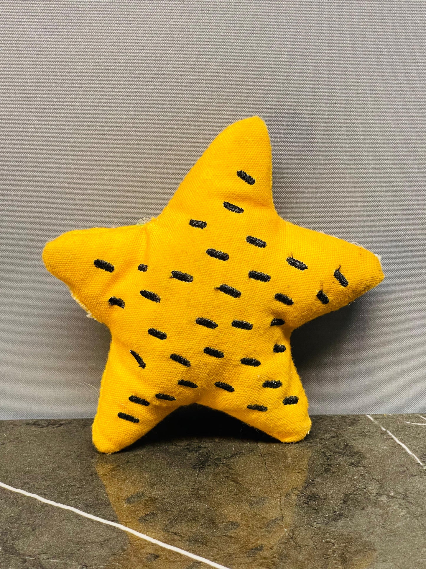 Yellow star-shaped plush toy.