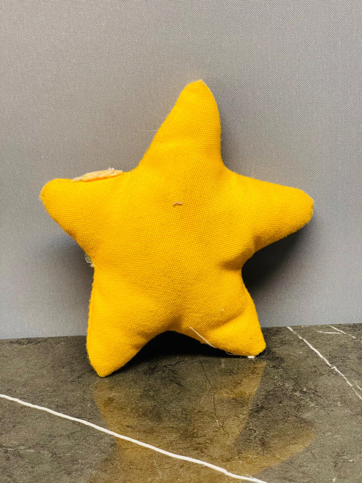 Yellow star-shaped plush toy.