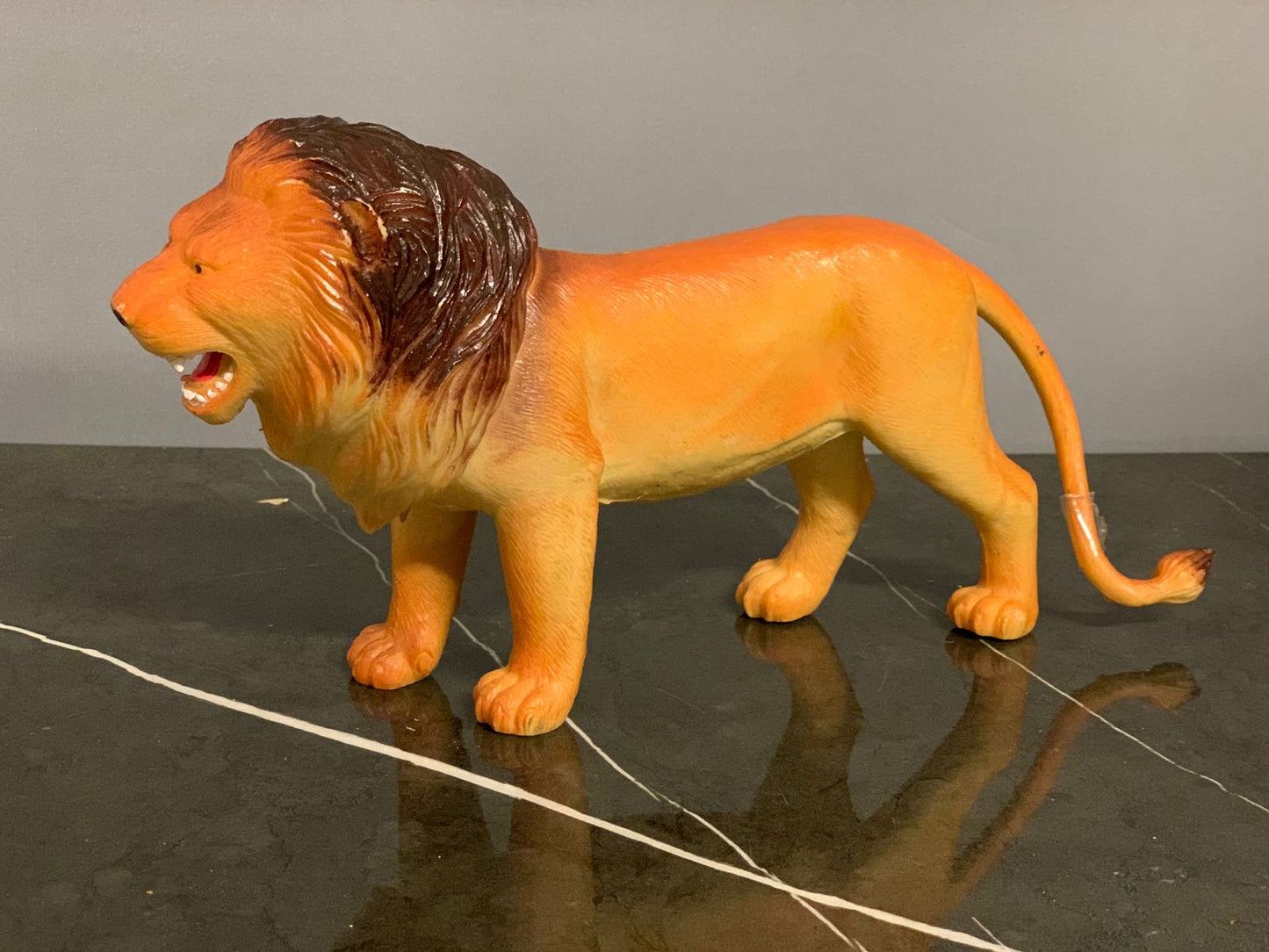 Realistic Plastic Lion Figure.
