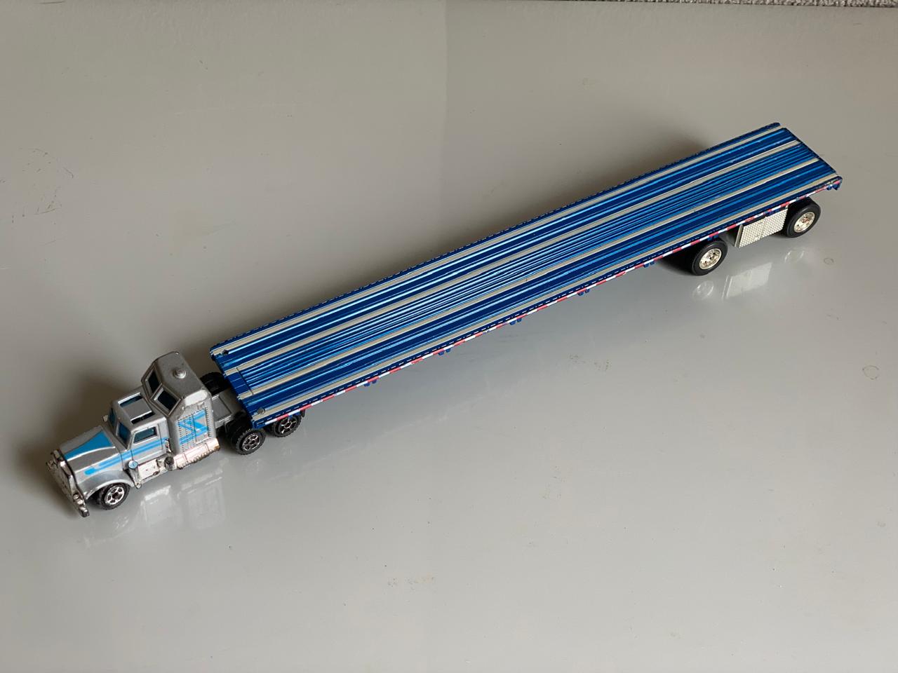 Peterbilt Conventional Metal Semi-Truck with Flatbed Trailer.