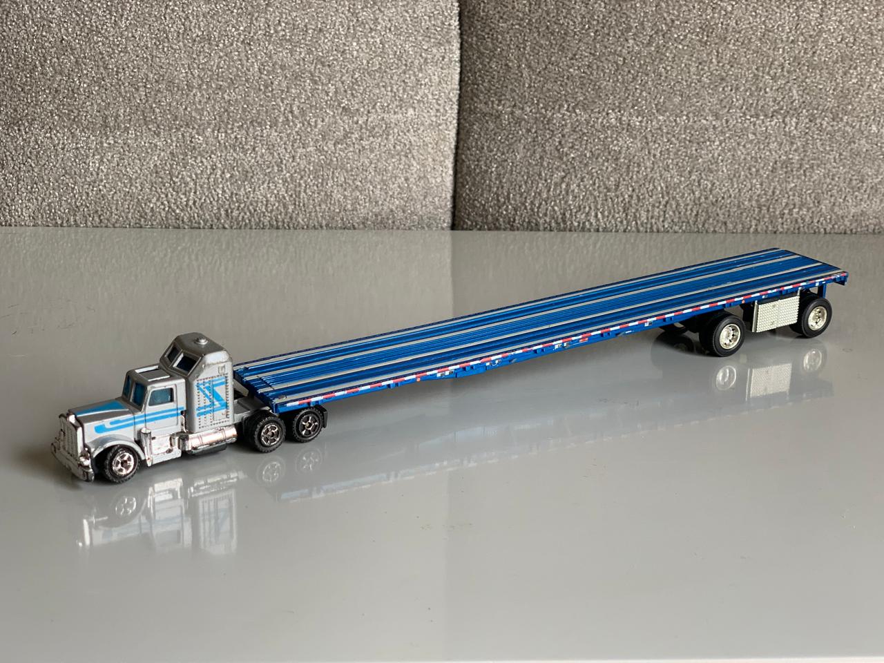 Peterbilt Conventional Metal Semi-Truck with Flatbed Trailer.