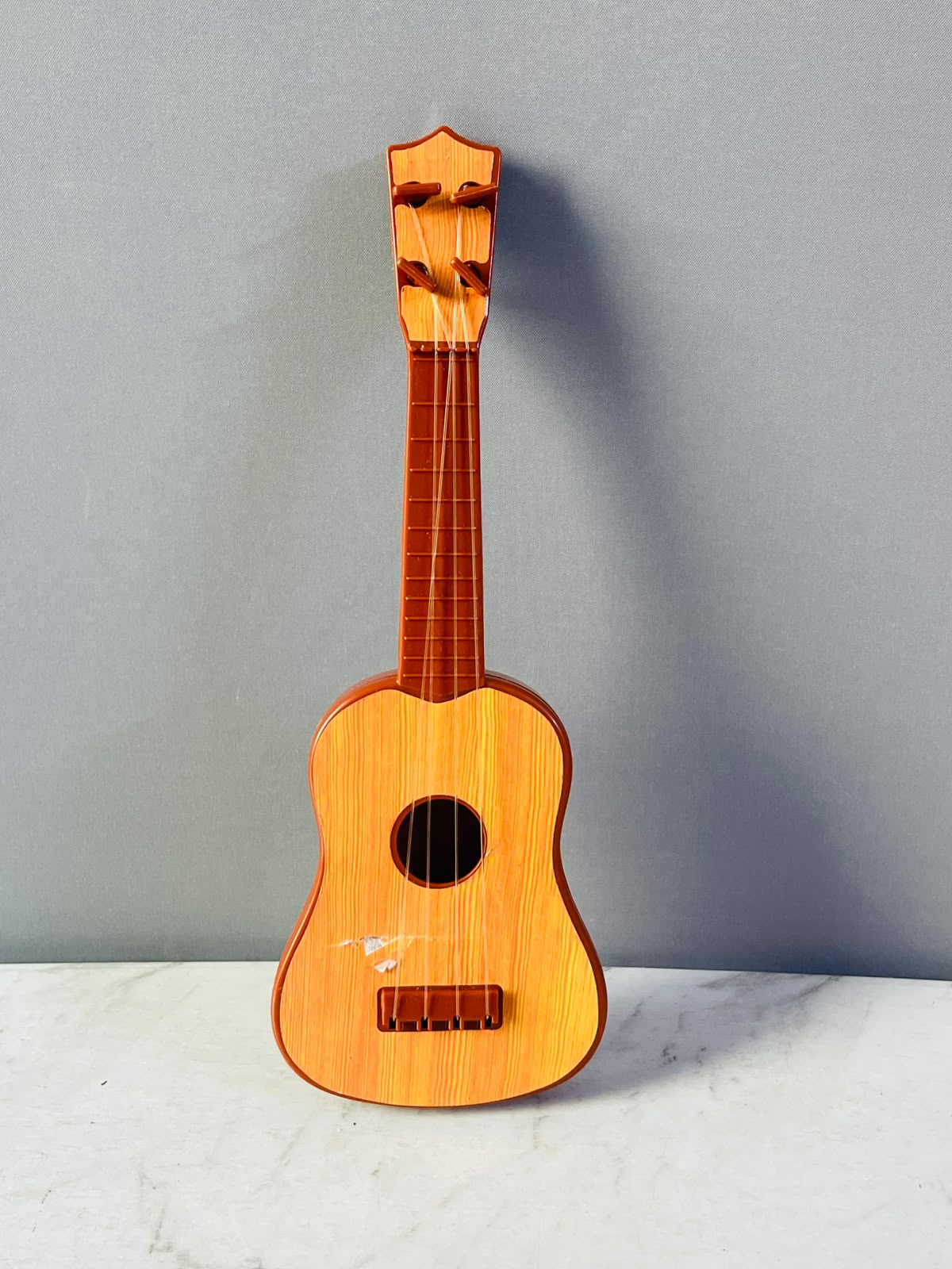 The Teissuly Kids Toy Guitar Ukulele (Rs 300)