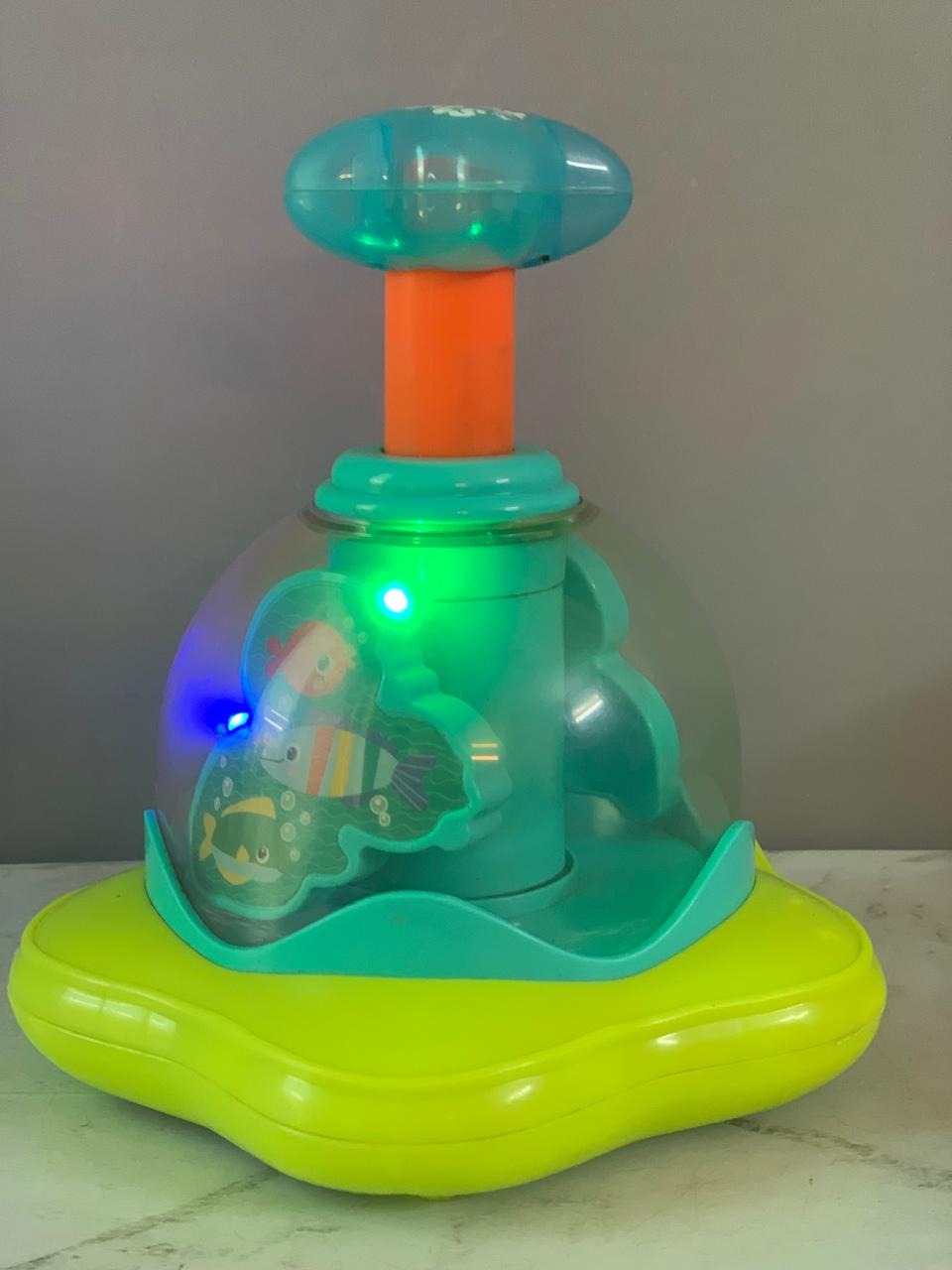 Bright Starts Press and Glow Spinner Cause and Effect Musical Baby Toy.(batteries cover missing)(Rs 250 advance)