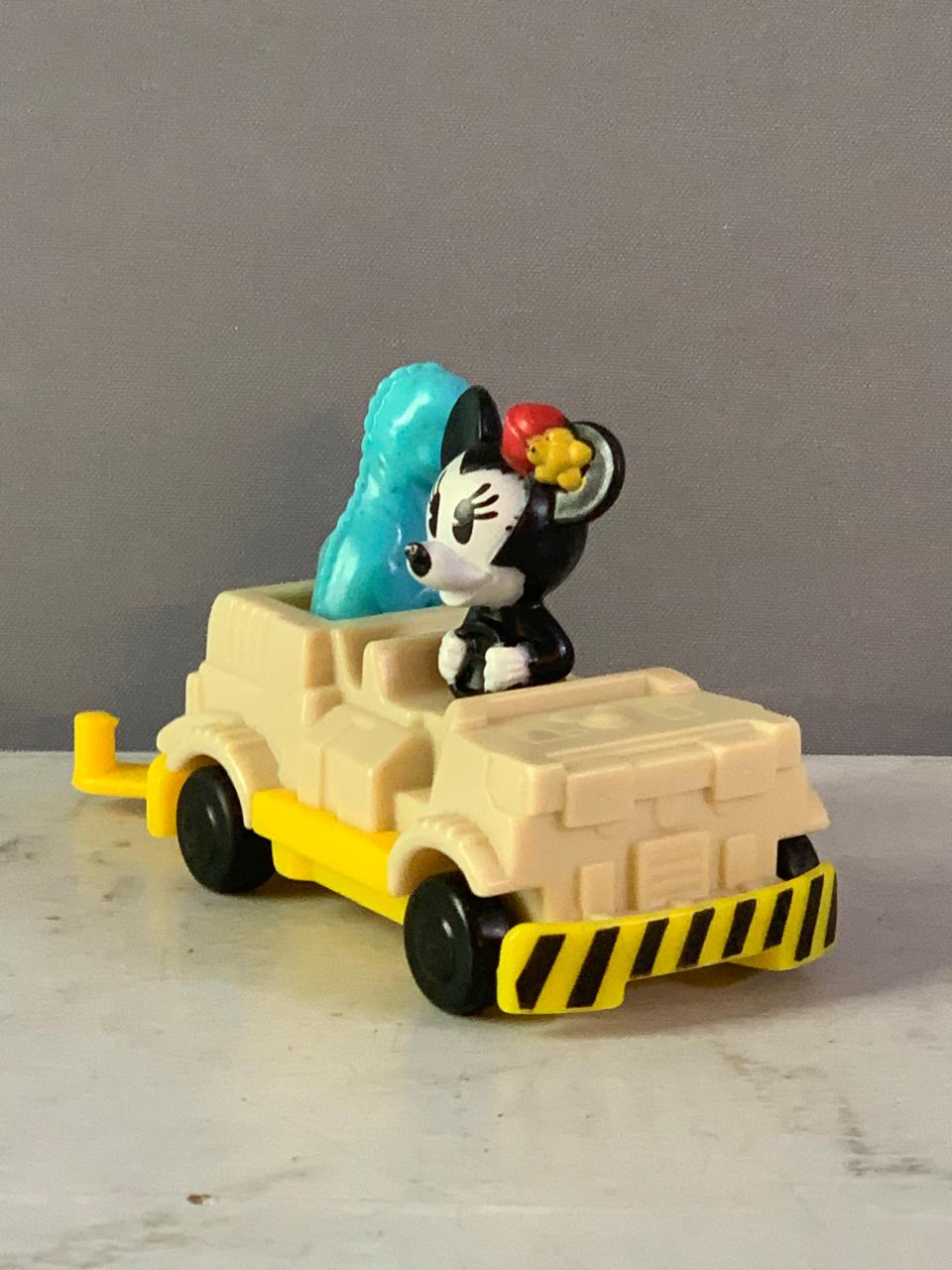 Minnie Mouse in a dinosaur ride vehicle