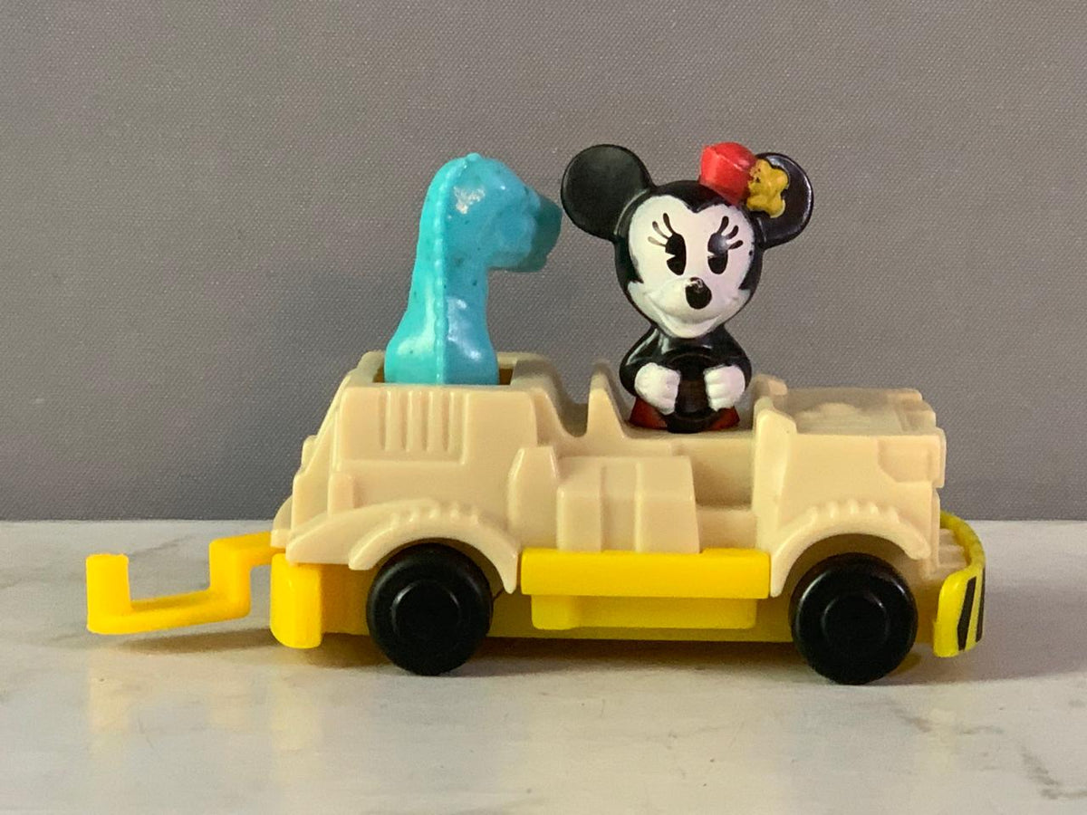 Minnie Mouse in a dinosaur ride vehicle