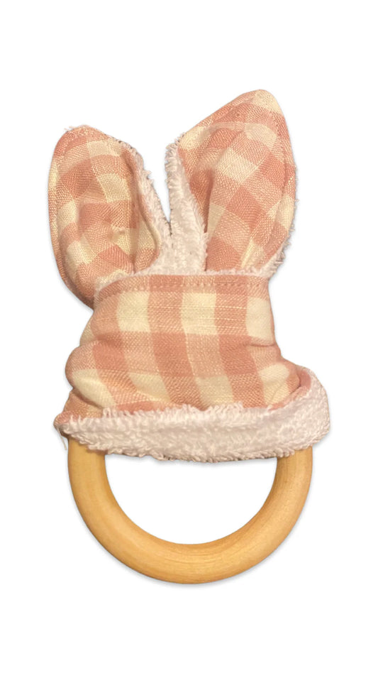 Baby teething ring with fabric bunny ears and a bow.