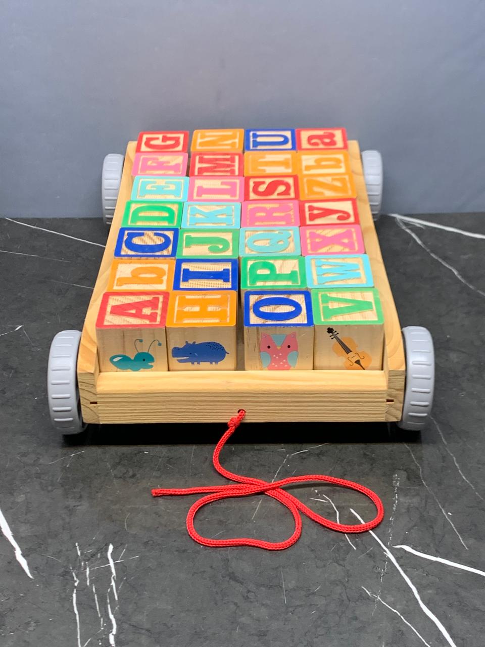 Wooden Pull Along ABC Blocks Cart. (Rs 450 advance) SKU:BXL-005